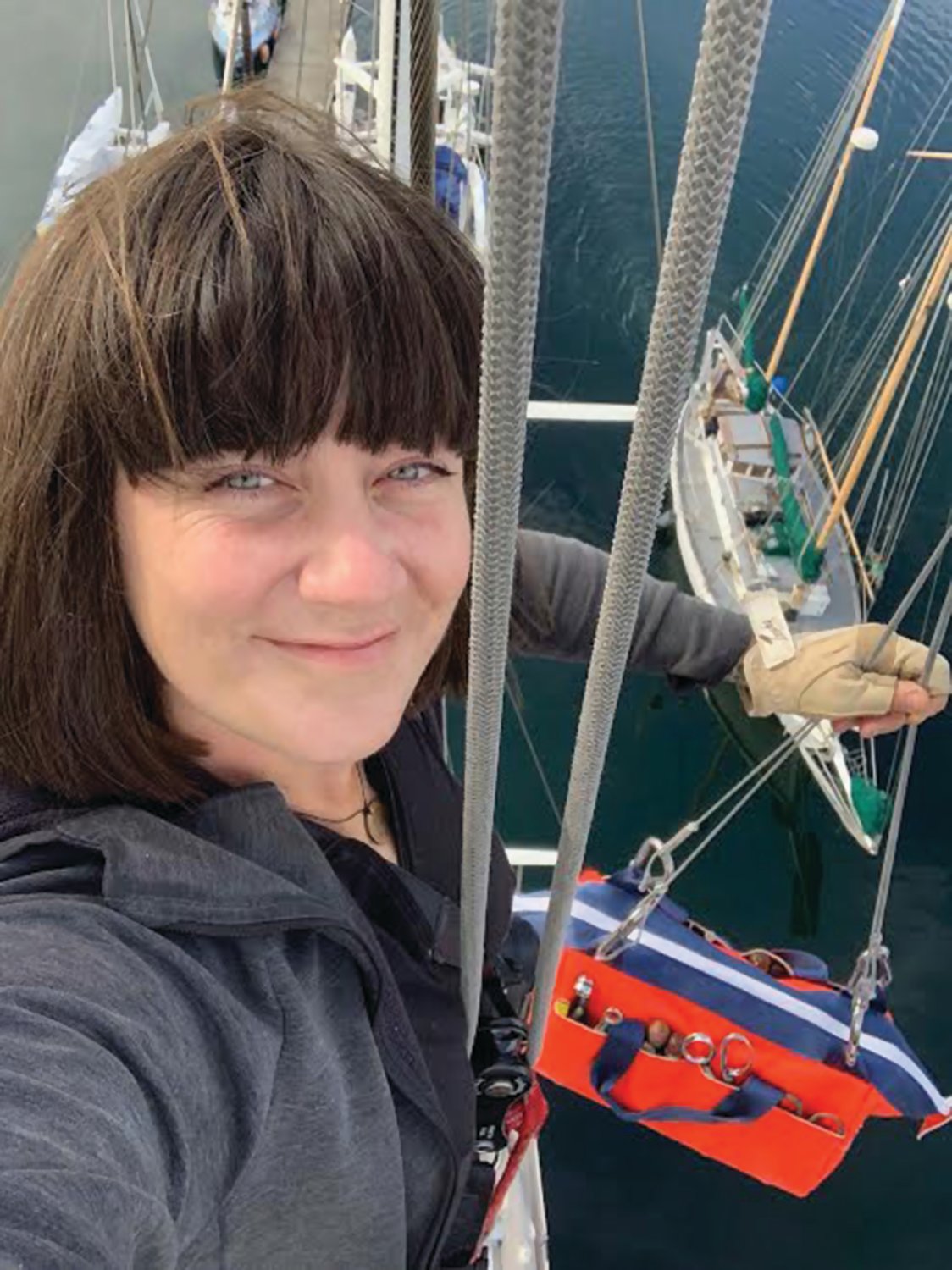 Randi Whipple perches atop the 73-foot mast of the “Wolfhound,” owned by Steven and Louise Dew in Port Townsend.